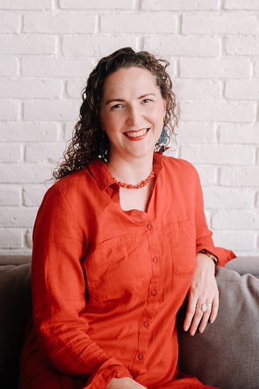 Curly Haired lady smiling